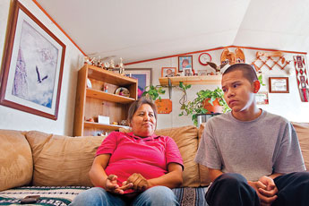 Linda Joe sits with her adopted son Matthew Joe at their home Wednesday. © 2011 Gallup Independent / Cable Hoover